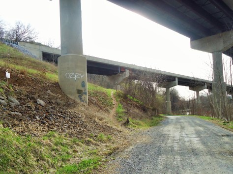 Trail goes right under I-81 then veers uphill to the left.
